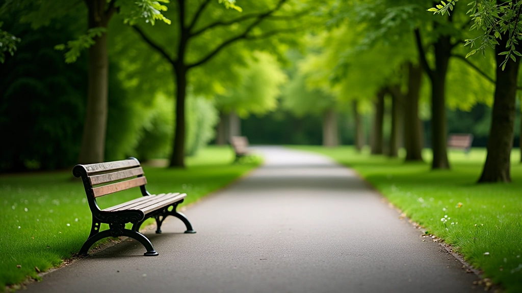Accessible park bench with clear sightlines across green lawn and tree-covered areas